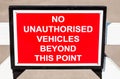 NO UNAUTHORISED VEHICLES BEYOND THIS POINT road sign.