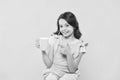 No use crying over spilt milk. Drink enough water. Girl kid hold mug yellow background. Carefree smiling child pointing