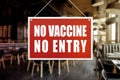 No Vaccine No Entry Sign at a restaurant or indoor cafe. Proof or vaccination required to enter a shop or business establishment