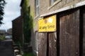 No Waiting sign attached to a private fence down a very narrow, one way street