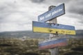 No war please text quote on wooden signpost outdoors on nato colored flag, ukrainian flag and russian flags