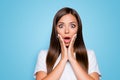 NO WAY Close up portrait of frustrated girl with wide open eyes mouth holding palms near cheeks looking at camera Royalty Free Stock Photo