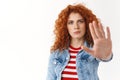 No way not my watch. Serious-looking displeased gloomy redhead curly-haired woman stretch palm camera taboo forbid