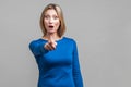 No way, that`s you! Portrait of wondered woman in tight blue dress pointing at camera. isolated on gray background Royalty Free Stock Photo