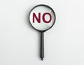 NO word through magnifying glass on light blue gray background Royalty Free Stock Photo