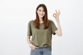 No worries, everything is okay. Portrait of confident calm attractive woman in dark-green t-shirt, holding hand in