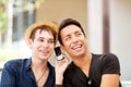 No...youre not on loudspeaker. a handsome young man talking on his cellphone while his friend listens in. Royalty Free Stock Photo