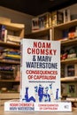 Noam Chomsky and Marv Waterstone\'s Consequences of Capitalism book in the bookshop.