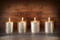 Noble candles against a background of wood