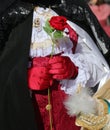 noble lover wearing red gloves hands a red rose to his beloved Royalty Free Stock Photo