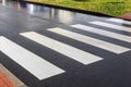 Nobody on crosswalk in clack and white crosswalk lines after rain wet