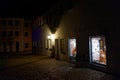 Deserted market place by lighted store windows night scene