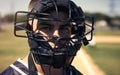 Because nobody likes getting smashed by a ball. Portrait of a young man wearing a catchers helmet while playing a game Royalty Free Stock Photo