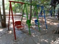 swing in the garden, empty swings in the playground, colorful swings in the park Royalty Free Stock Photo