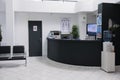 Nobody in waiting room with front desk reception and wall screen tv with promotional offer