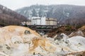 Noboribetsu Jigokudani Hell Valley with hotel and mountain: The volcano valley got its name from the sulfuric smell. Royalty Free Stock Photo