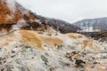 Noboribetsu Jigokudani Hell Valley with hotel and mountain: The volcano valley got its name from the sulfuric smell. Royalty Free Stock Photo