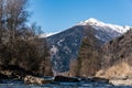 Noce River surrounded by snow-capped mountains Italian Alps Dolomities