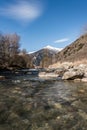 Noce River surrounded by snow-capped mountains Italian Alps