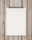 Nock up blank white hanging poster on vertical wooden planks wall, background