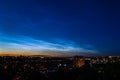 Noctilucent clouds during night time, city scape. Highest clouds in the Earth`s atmosphere, beautiful sky phenomenon. Royalty Free Stock Photo