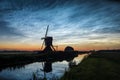 Noctilucent clouds over dutch landscape with windmill along the water of a canal Royalty Free Stock Photo
