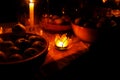 Nocturnal feast held in nature with enchanting lotus shape cande holders. Royalty Free Stock Photo