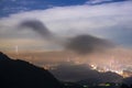 Nocturnal Marvel: City Lights and Shifting Cloudscape from the Summit.