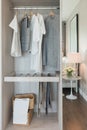 Nodern walk in closet interior design with clothes hanging on ra Royalty Free Stock Photo