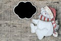 Noel background with carved bear and blank chalkboard on wood table