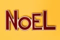 A Noel Sign isolated on a yellow background Royalty Free Stock Photo