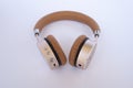 Golden headphones on white closeup