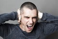 Noise and hearing concept for enraged young man screaming Royalty Free Stock Photo