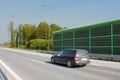 Highway noise barrier, acoustic screen. Car on the sound-absorbing tunnel