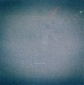 Noisy blue film frame with scratches, dust and grain.