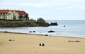 Noja, Spain - April 2nd 2015: A group of young on the beach