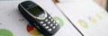 Nokia 3310 ol phone with business chart Royalty Free Stock Photo