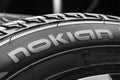 Nokian Tyres-the logo of the tire manufacturer on the sidewall of the tire in close-up. car wheel, white disc