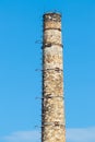 old brick chimney against the sky