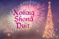 Nollaig Shona Duit means Merry Christmas in Irish. Blurred background of decorated Christmas tree with golden lights. Fireworks. Royalty Free Stock Photo