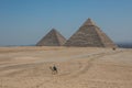 Nomad on camel near pyramids in egyptian desert Royalty Free Stock Photo