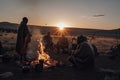 nomadic tribe cooking over open fire, with view of the sunset Royalty Free Stock Photo