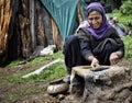 A nomad gujjar women polishing earthen stove on a mountain range of village daksum Anantnag kashmir