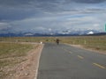 A nomads ride a motorcycle on the sky road in Tibet