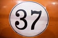 Nomber 37 on retro car dood orange background