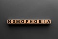 Nomophobia - word from wooden blocks with letters