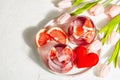 Non-alcoholic cocktail with grapefruit. An iced drink is served in glasses. St.Valentine`s symbol