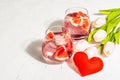 Non-alcoholic cocktail with grapefruit. An iced drink is served in glasses. St.Valentine`s symbol