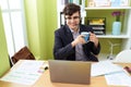 Non binary man call center agent drinking coffee working at office Royalty Free Stock Photo