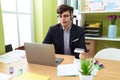 Non binary man call center agent using computer and credit card working at office Royalty Free Stock Photo